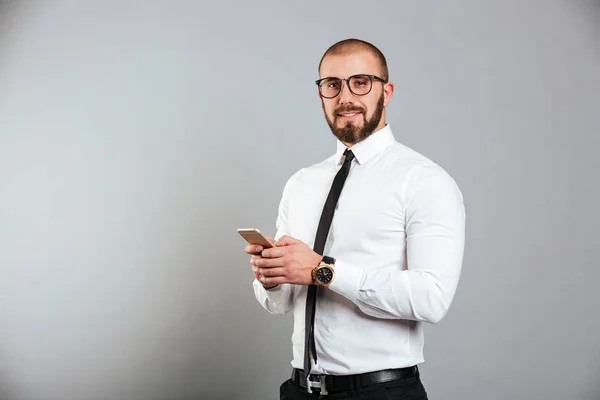 Photo of successful mature man in glasses and tie communicating — Stock Photo, Image