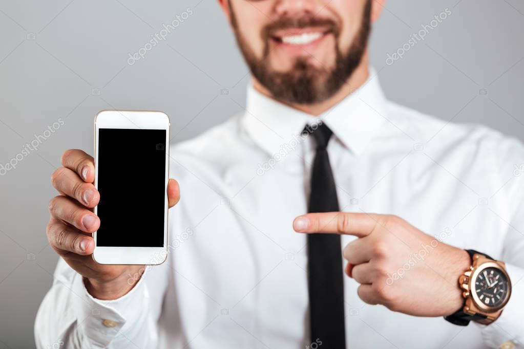 Close up of a smiling businessman pointing finger