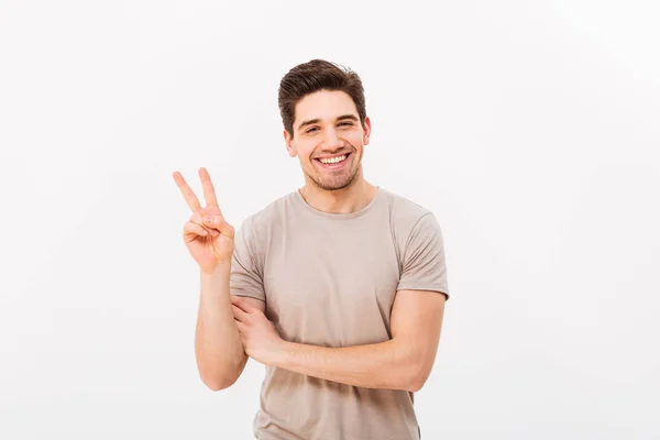 Studio photo of good-looking man showing peace symbol on camera — Stock Photo, Image