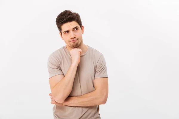 Photo of pensive man propping up chin and posing aside with seri — Stock Photo, Image