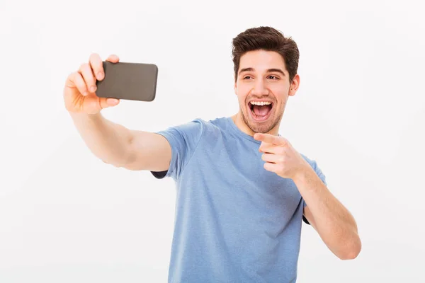 Image of man 30s with brown hair smiling and pointing finger on — Stock Photo, Image