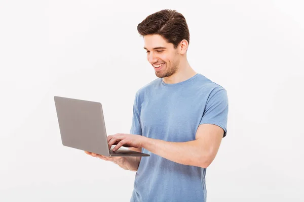 Picture of satisfied unshaved man in casual t-shirt holding silv — Stock Photo, Image