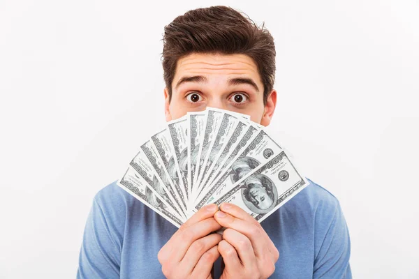 Photo of funny man in casual t-shirt covering his face with fan — Stock Photo, Image