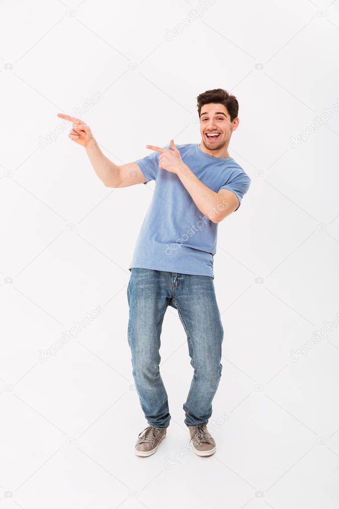 Full-length image of handsome man rejoicing and pointing fingers