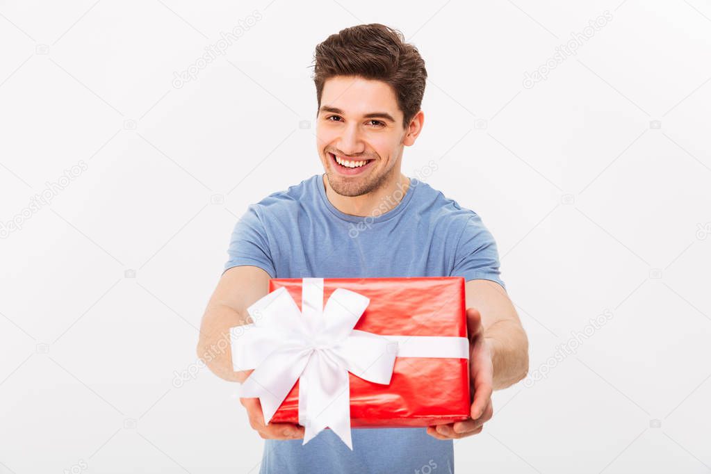 Kind attractive man with beautiful smile giving birthday present