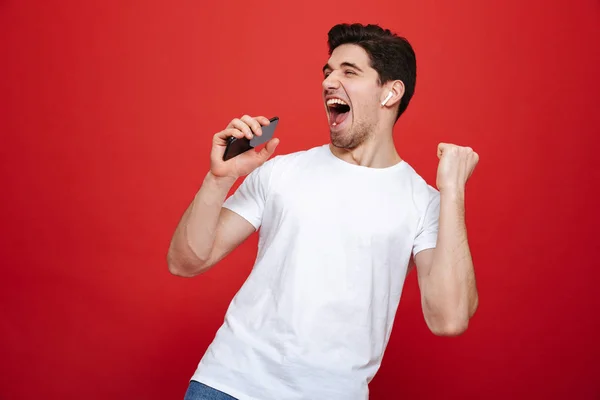 Portrait of a joyful young man in white t-shirt — Stock Photo, Image