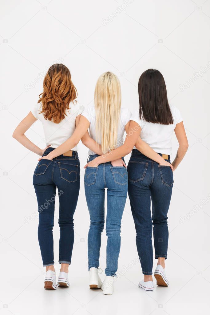 Back view full length portrait of three slim casual girls