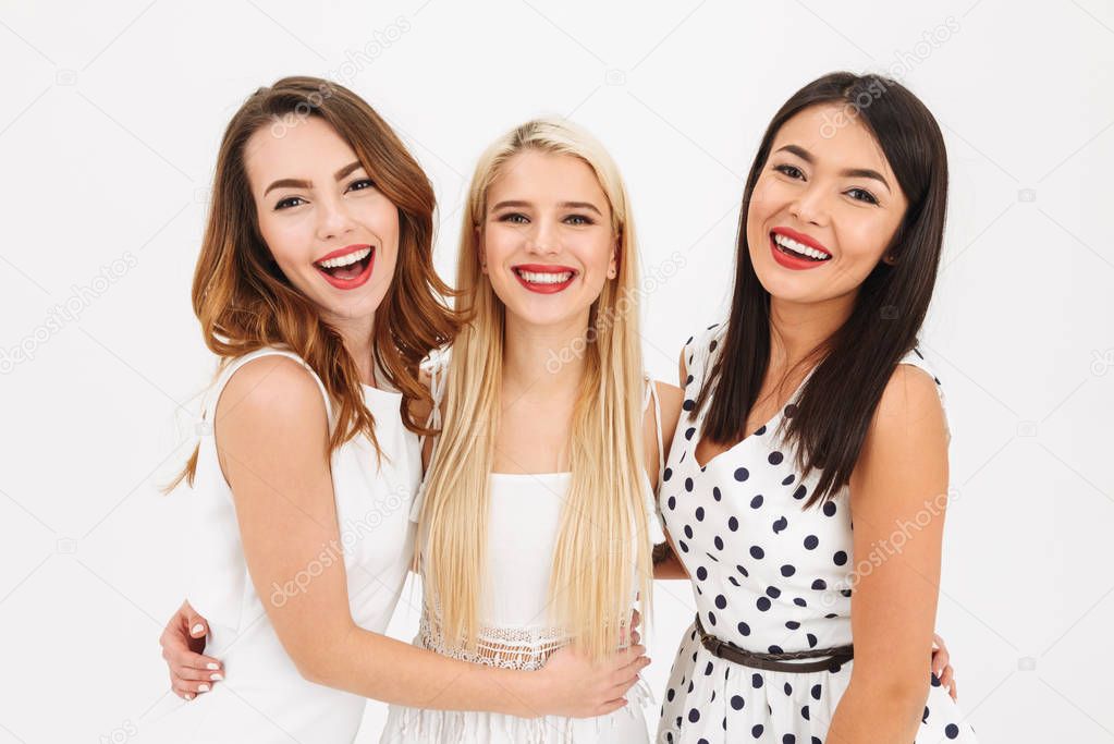 Portrait of three happy young girls smartly dressed