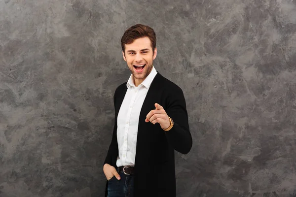 Happy young businessman pointing. — Stock Photo, Image