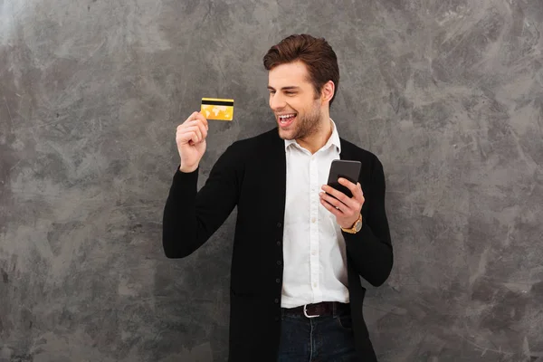 クレジット カードを保持している携帯電話でチャットの実業家. — ストック写真
