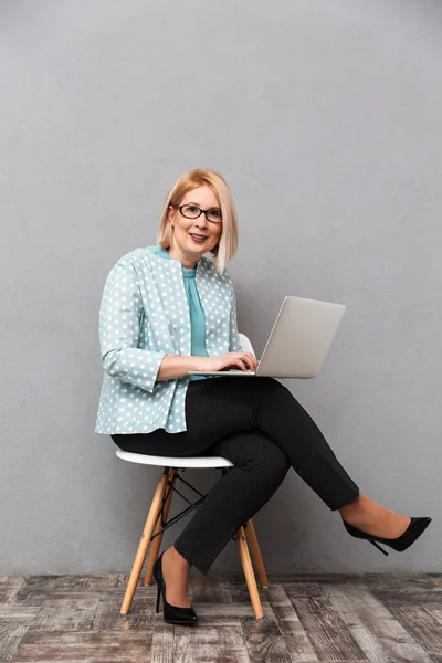 Mulher de negócios alegre usando computador portátil . — Fotografia de Stock