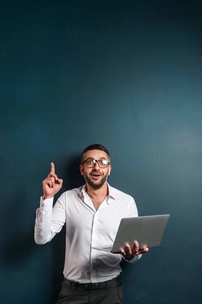 Emotional man wearing glasses have an idea using laptop computer. — Stock Photo, Image