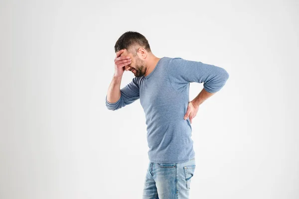 Displeased young man with dorsodynia — Stock Photo, Image