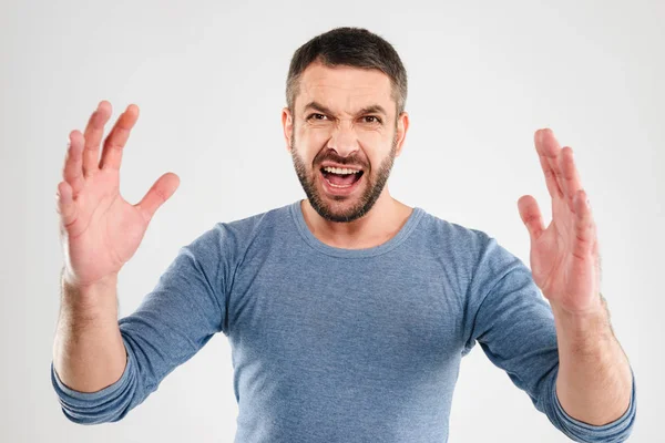 Angry screaming displeased man standing isolated — Stock Photo, Image