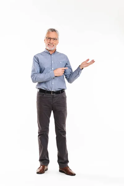 Smiling man showing with hands at copy space isolated — Stock Photo, Image