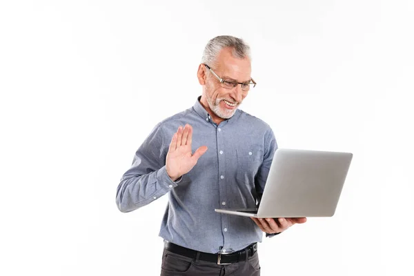 Happy mature man making videocall with laptop computer isolated — Stock Photo, Image