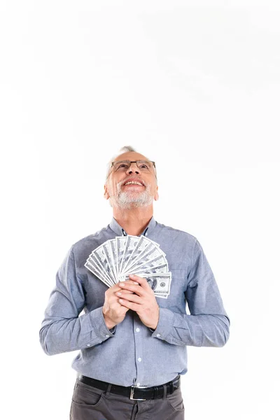 Happy man holding dollars and looking up isolated — Stock Photo, Image