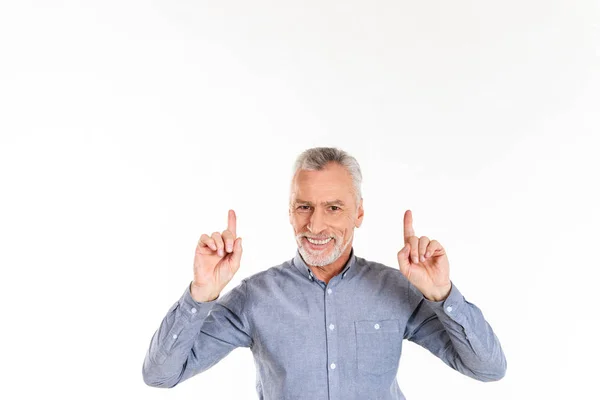 Smiling man pointing up with fingers and looking camera isolated — Stock Photo, Image