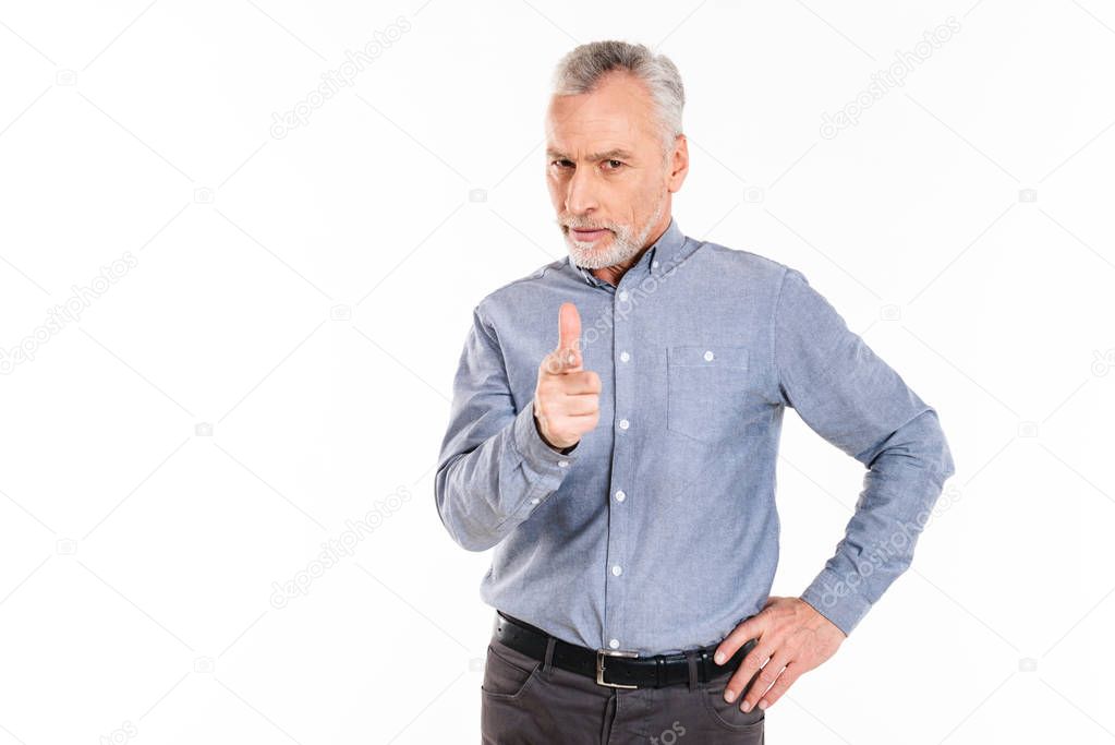 Serious confident man pointing at you with finger