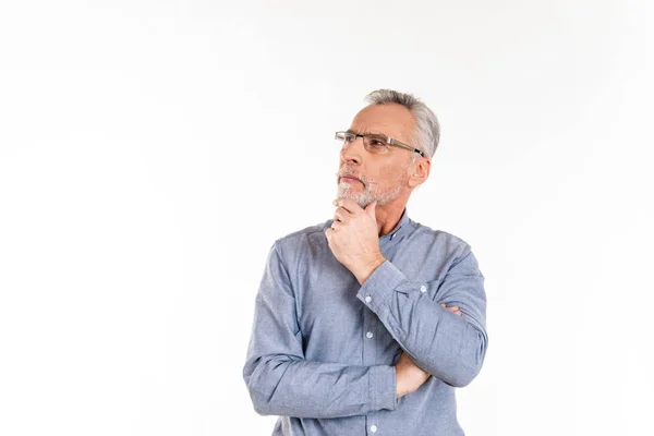 Thoughtful man looking up at copy space while standing isolated — Stock Photo, Image