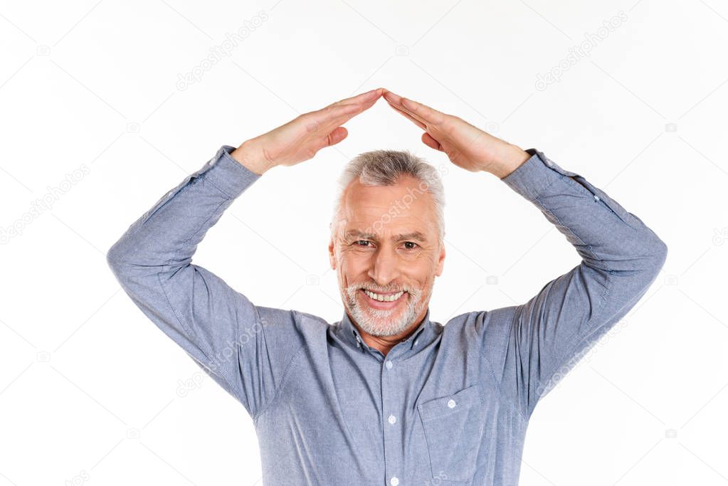 Old man looking camera and holding hands above head isolated