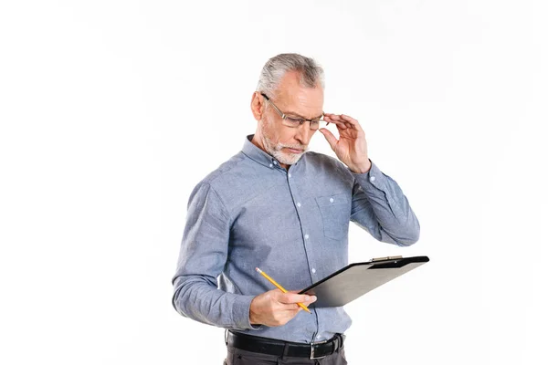 Serious concentrated man looking at folder isolated over white — Stock Photo, Image
