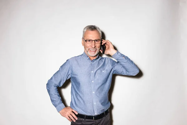 Fröhlicher Mann, der auf dem Smartphone isoliert über Weiß spricht — Stockfoto
