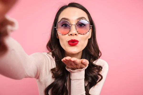 Cute lady in casual shirt with red lips wearing round sunglasses