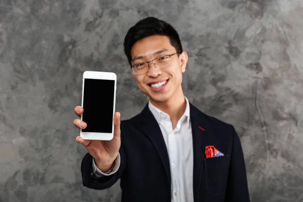 Portrait of a confident young asian man dressed in suit — Stock Photo, Image