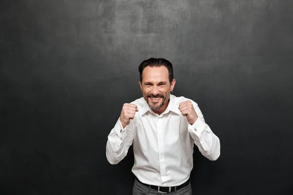 Portrait of a happy mature man dressed in shirt celebrating — Stock Photo, Image