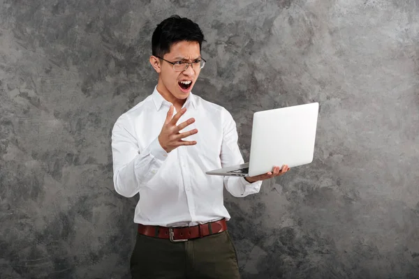 Portrait of an angry young asian man — Stock Photo, Image