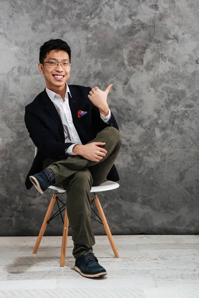 Full length portrait of a satisfied young asian man — Stock Photo, Image