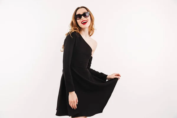 Happy elegant woman in dress and sunglasses posing — Stock Photo, Image