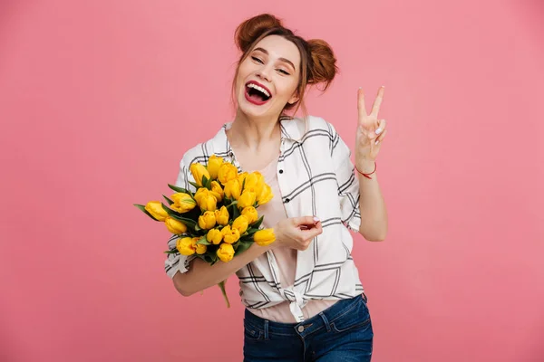 Retrato de uma menina rindo segurando tulipas amarelas — Fotografia de Stock