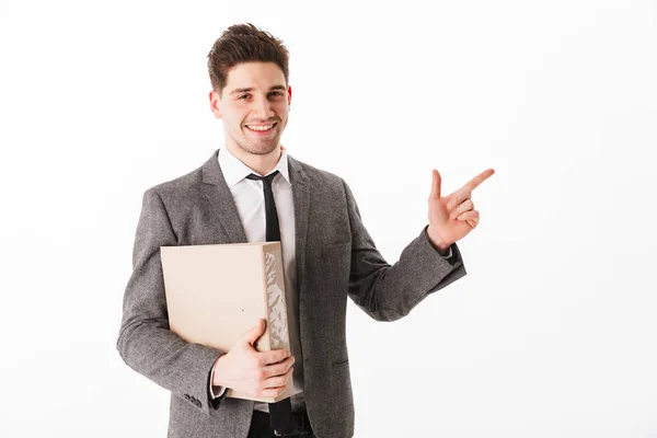 Smiling man in jacket holding folder and pointing on copyspace — Stock Photo, Image