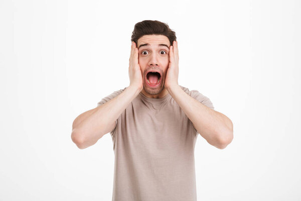 Portrait of positive guy with bristle and brown hair screaming i