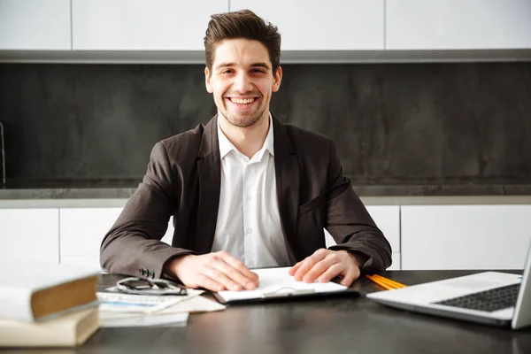 Cheerful young businessman working indoors — Stock Photo, Image