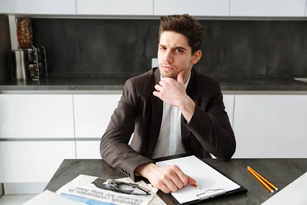 Serious young businessman working indoors — Stock Photo, Image