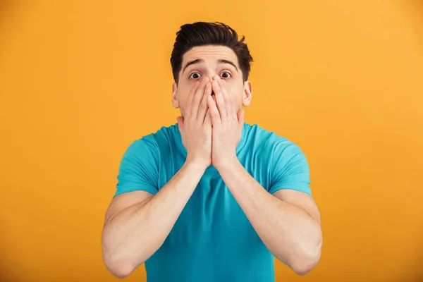 Portrait of an astonished young man in t-shirt — Stock Photo, Image