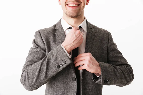 Cropped image of smiling business man in jacket corrects tie — Stock Photo, Image