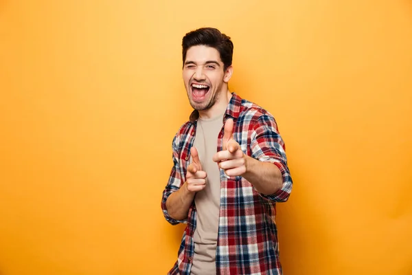 Portrait of an excited young man pointing — Stock Photo, Image