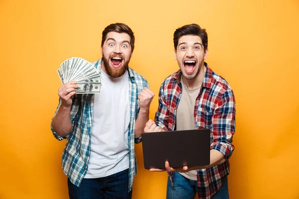 Portrait of a two happy young men holding laptop computer — Stock Photo, Image
