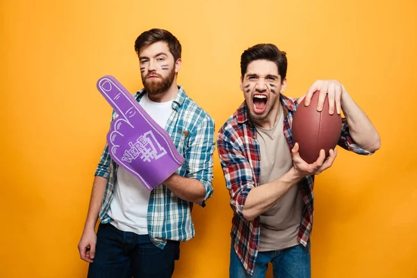 Portrait of a two cheerful young men holding rugby ball — Stock Photo, Image