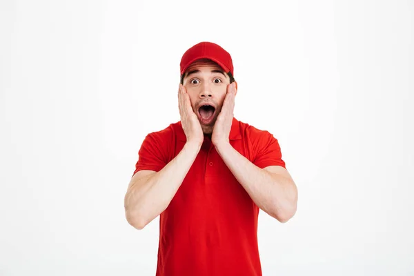 Shocked young delivery man — Stock Photo, Image