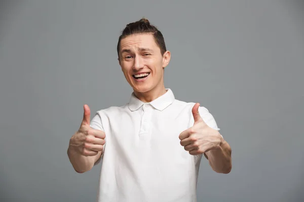 Happy young man showing thumbs up. — Stock Photo, Image