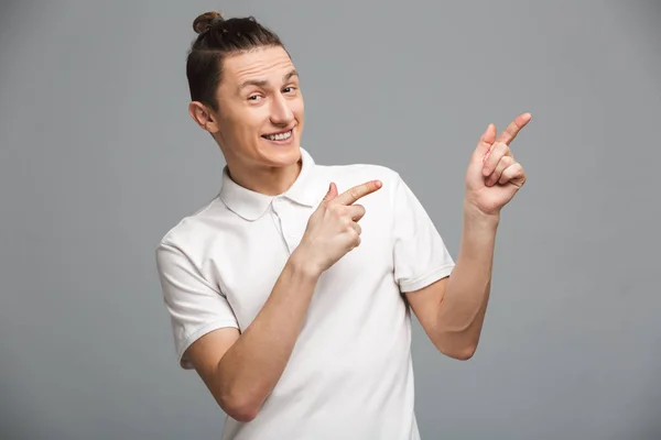 Happy young man pointing. — Stock Photo, Image