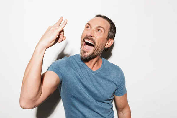 Portrait of a joyful mature man dressed in t-shirt — Stock Photo, Image