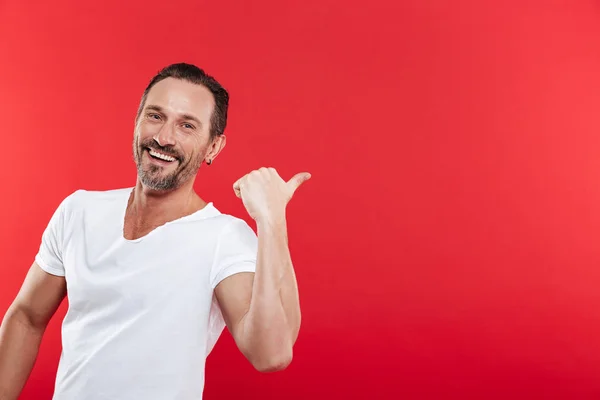 Cheerful adult man pointing. — Stock Photo, Image