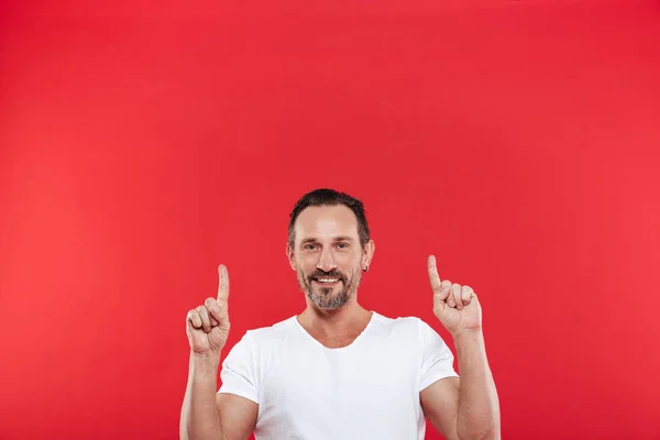 Cheerful adult man pointing. — Stock Photo, Image