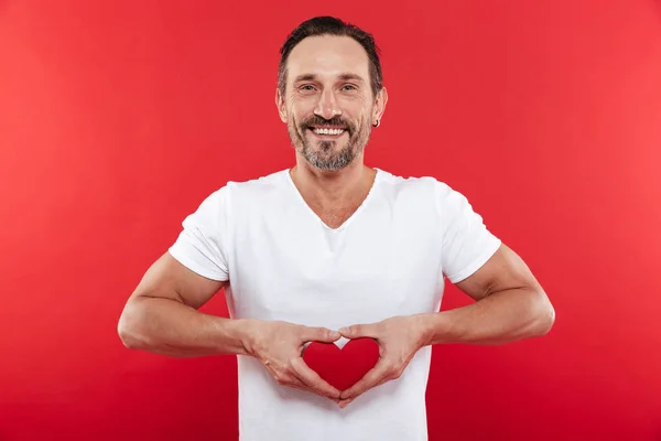Photo of handsome romantic man in casual white t-shirt smiling a — Stock Photo, Image